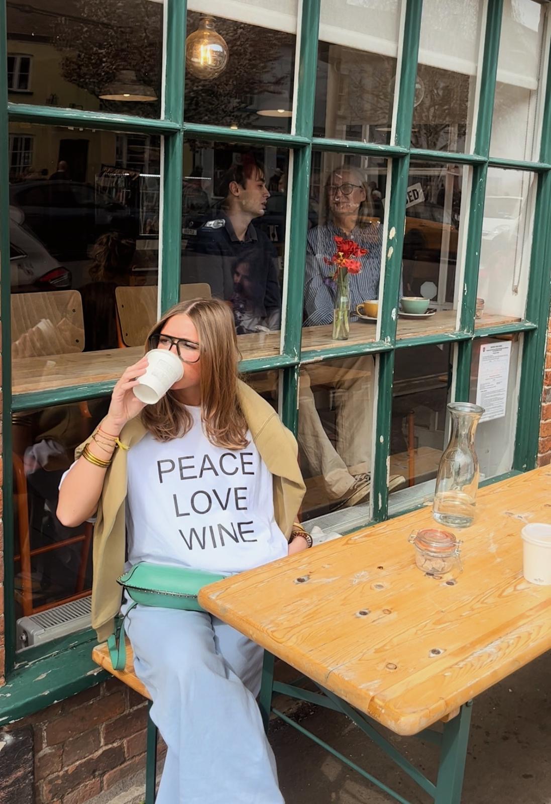 New In Peace Love Wine Slogan Boxy White Fit Organic Cotton Tee with a Black font.