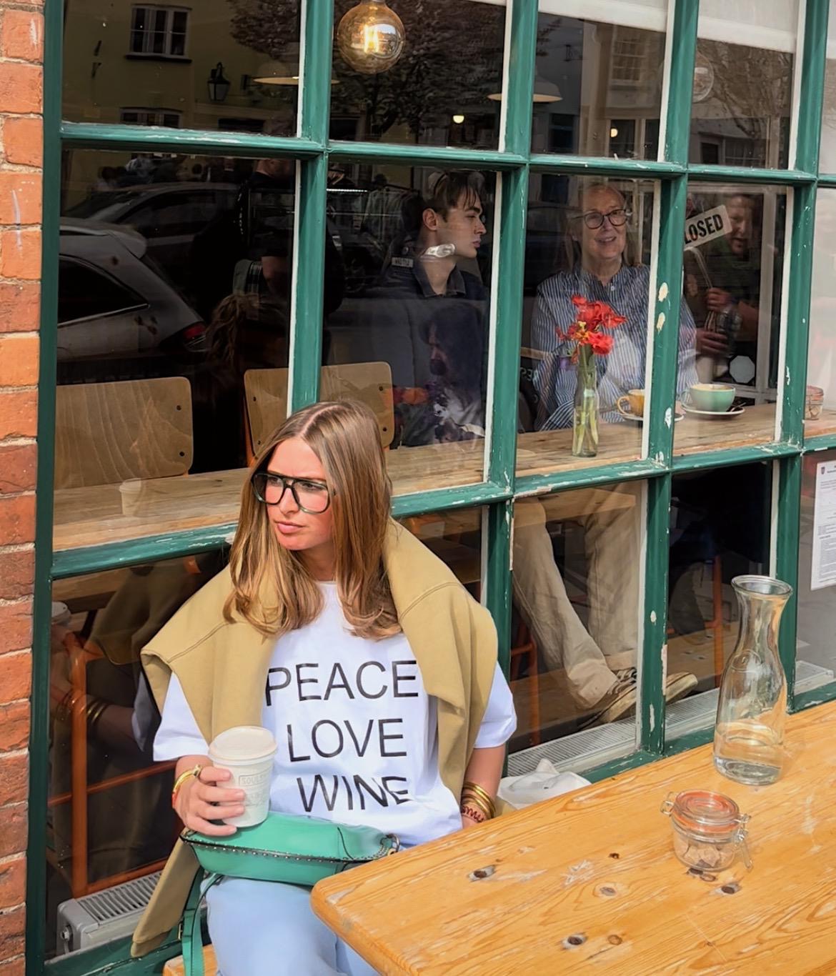 New In Peace Love Wine Slogan Boxy White Fit Organic Cotton Tee with a Black font.